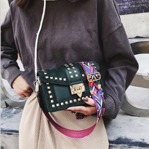 Hunter green gold studded delineate fun bag.